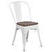 A white metal Flash Furniture restaurant chair with a wooden seat and vertical slats.