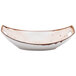 A white oval china bowl with brown specks on it.