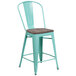 A mint green metal restaurant bar stool with a wood seat and vertical slat back.