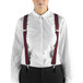 A woman wearing Henry Segal burgundy suspenders over a white shirt.