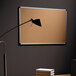 A black lamp next to a MasterVision cork board with aluminum and black corners.