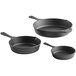 A group of black cast iron skillets.