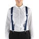 A woman wearing Henry Segal navy elastic clip-end suspenders over a white shirt.