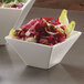 Two white American Metalcraft square bowls filled with salad.