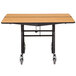 A National Public Seating 48" square cafeteria table with wheels on it.