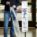 A man using an LK Packaging long plastic umbrella bag with a handle.