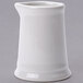 A white ceramic Tuxton creamer container with a handle.