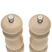 Two wooden salt and pepper mills with a metal cap.