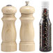 A wooden salt shaker with a lid and a wooden pepper mill.