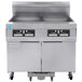 A large stainless steel commercial Frymaster gas floor fryer with two drawers and two doors.