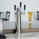 An Avantco silver beer tap on a counter.