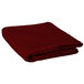 A folded red Intedge 100% polyester table cover on a white background.