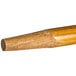 A close up of a Carlisle wood broom/squeegee handle.