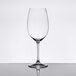 A clear Spiegelau Bordeaux wine glass on a reflective surface.