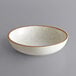 An Acopa Keystone stoneware coupe low bowl in white with brown specks.