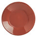A round red porcelain bowl with a black rim.