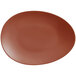 A brown porcelain coupe plate with an oval shape and small rim on a white background.