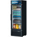 A Turbo Air black glass door refrigerator full of sodas and other beverages.