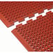Two red Cactus Mat Duralok floor mats with beveled edges and holes.