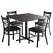 A brown rectangular Lancaster Table & Seating butcher block table with four black chairs around it.