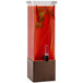 A Rosseto clear acrylic beverage dispenser with bronze base filled with red liquid.
