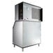 A large silver Manitowoc air cooled ice machine with a black door.