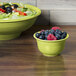 A bowl of salad and fruit in a Fiesta Lemongrass china bowl.