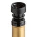 A black and gold wine bottle with a Franmara black wine stopper/pourer.