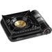 A black gas stove with a gold rim.