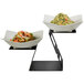 A Rosseto black matte riser with two bowls of food on a table.