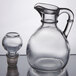 A close-up of a Libbey glass cruet with a stopper.