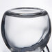 A clear glass cruet with a handle on top and a stopper.