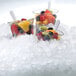 A group of fruit cups with flake ice in them.