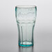 A clear plastic GET soda glass with a blue Coca-Cola logo.