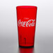 A close up of a red GET Coca-Cola plastic tumbler with white text.