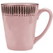A pink stoneware mug with black lines on it.