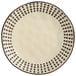 A white stoneware salad plate with black dots on it.