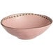 A pink stoneware bowl with gold trim.