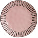 A pink stoneware salad plate with black dots.