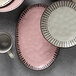 A pink Libbey stoneware platter on a table.