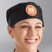 A woman smiling wearing a black Choice chef hat.