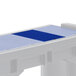 A navy blue rectangular cover with white accents over a table with a white rectangular pad.