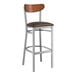 A Lancaster Table & Seating bar stool with a dark brown vinyl seat.