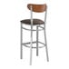 A Lancaster Table & Seating bar stool with a brown vinyl seat.