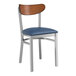 A Lancaster Table & Seating metal chair with a navy blue vinyl seat and antique walnut wood back.