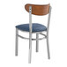 A Lancaster Table & Seating metal chair with a navy vinyl seat and back.