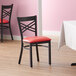 Lancaster Table & Seating Black Finish Cross Back Chair with 2 1/2" Red Vinyl Padded Seat Main Thumbnail 1