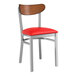 A Lancaster Table & Seating Boomerang chair with a red vinyl seat and wooden back.