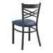 A Lancaster Table & Seating black metal cross back chair with a navy blue padded seat.