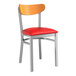 A Lancaster Table & Seating Boomerang chair with a red vinyl seat and cherry wood back.